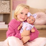 Lalka niemowlę ze smoczkiem, w ubranku w kwiatuszki i opasce, fioletowa / LullaBaby