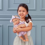 Lalka niemowlę ze smoczkiem, w ubranku w kwiatuszki i opasce, fioletowa / LullaBaby