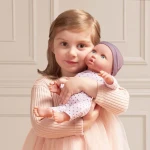 Lalka niemowlę ze smoczkiem, w piżamce w kropeczki i czapeczce / LullaBaby